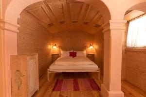 海利根布卢特Hotel Kaiservilla的小型客房的一张床位,设有木制天花板