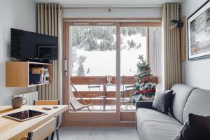 美贝尔RESIDENCE OLYMPIE 1的带沙发和圣诞树的客厅
