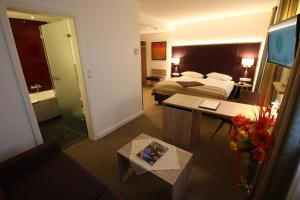 波恩阿德勒高级酒店的酒店客房设有床和客厅。
