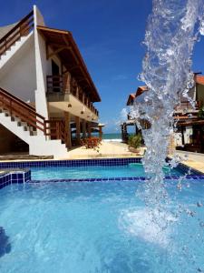 伊塔皮波卡Pousada e Restaurante Altas Horas Beach的水喷泉在房子前面