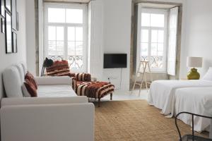波尔图莫豪斯旅馆的白色的客房配有两张床和电视。