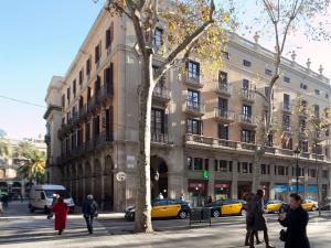 巴塞罗那HOTEL FORNOS - Barcelona的一群人走在大楼前的街道上