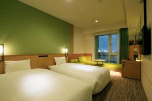 THE SINGULARI HOTEL & SKYSPA at UNIVERSAL STUDIOS JAPAN客房内的一张或多张床位