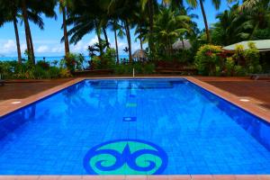 Fuailalo瓦萨度假酒店的棕榈树度假村的游泳池