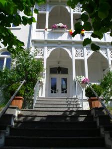 奥斯赛拜-塞林豪斯英特拉施塞林公寓的白色的房子,门上设有楼梯和鲜花