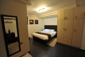 约阿尼纳迪卢索之家酒店的一间卧室配有一张床和镜子