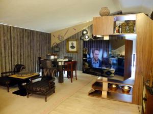 圣玛丽亚大德费拉Family Secrets Santo André的带电视的客厅和带桌子的客厅。