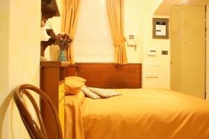 布拉格汀斯卡公寓式酒店的一间卧室设有一张黄色的床和窗户