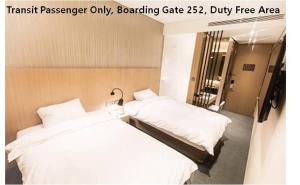 仁川市Terminal 2 Transit Hotel Incheon Airport的一间酒店客房内设有两张床的房间