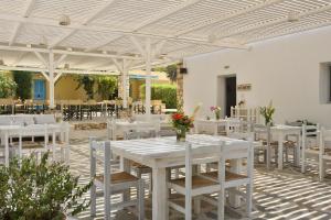 圣玛丽亚帕罗村冲浪海滩的白色的用餐室配有白色的桌椅