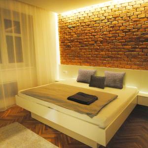 奥洛穆茨Apartments Centre in Style的一间卧室配有一张砖墙床