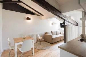 里昂里昂老城高地公寓的厨房以及带桌子和沙发的客厅。