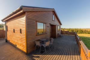 霍尔斯沃德吕尔Cozy Cottage by Stay Iceland的小木屋 - 带桌椅的甲板