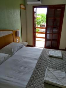 里奥格兰德波萨达伊斯奎纳度索尔酒店的卧室里一张带两条毛巾的床