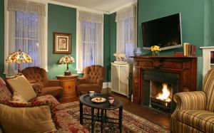 库珀斯敦The Inn at Cooperstown的客厅设有壁炉和电视。