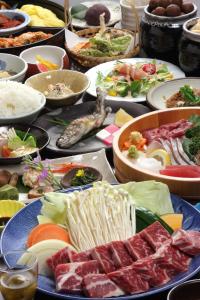 阿苏市阿苏博阿苏旅馆的一张满是不同种类食物的桌子