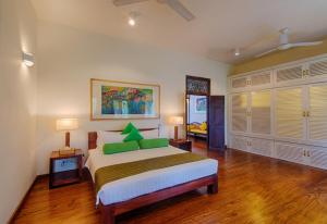 科伦坡Zylan Colombo的一间卧室配有一张带绿色枕头的大床