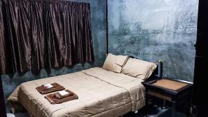 杭东ฺ班通龙民宿 的一间卧室配有一张床,上面放着两个托盘