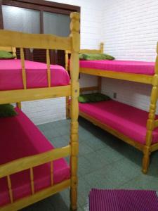 托雷斯Giuseppe & Giuseppin的配有两张双层床的宿舍间配有粉红色床单