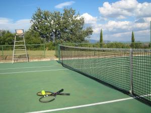PozzoFontelunga Hotel & Villas的网球场网球拍和球