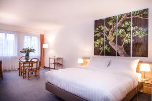 日内瓦Hotel Sagitta的卧室配有一张床,墙上挂着一幅大画