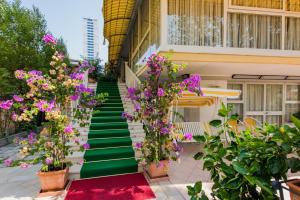 切塞纳蒂科多纳特罗酒店的一座带绿色楼梯的紫色花卉建筑
