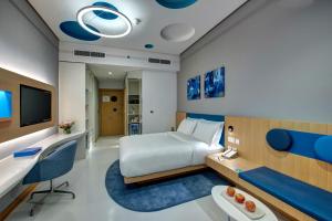 迪拜杜拜阿尔库利因布尔酒店的配有一张床和一张书桌的酒店客房