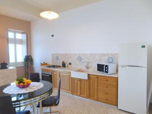 特拉帕尼Appartamento Belvedere的厨房配有桌子和白色冰箱。