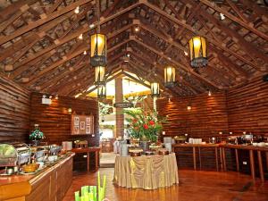 纳仲天Sunset Park Resort And Spa - SHA Plus的一间设有木制天花板和桌子的餐厅