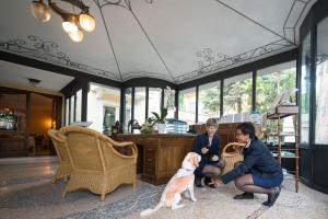 加尔多内-里维耶拉索非亚别墅酒店的客厅里有两个女人和一只狗