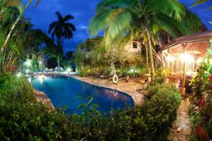 曼努埃尔安东尼奥Hotel Villas Nicolas - Adults Only的棕榈树度假村内的游泳池