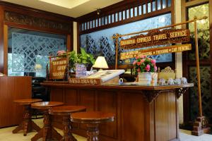 清迈Star Hotel Chiang Mai - SHA Extra Pus的酒吧,上面有凳子和电话