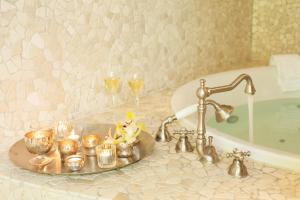 BubendorfBad Bubendorf Design & Lifestyle Hotel的浴室设有水槽、蜡烛和酒杯