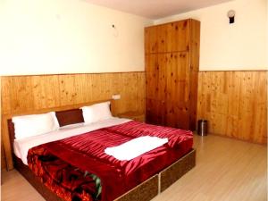 列城Hotel Abu Palace的一间卧室配有一张带木墙的大床