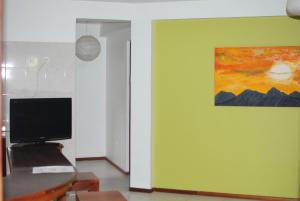 明德卢Residencial Raiar的一间设有绿色墙壁的房间,上面有绘画作品