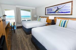 圣奥古斯丁海滩居伊哈维度假酒店客房内的一张或多张床位