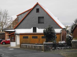 代斯特尔山麓巴德明德尔Ferienwohnung Papsdorf的屋顶上积雪的木屋