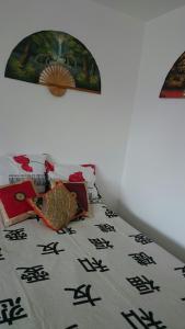 桑托斯Studio mobiliado的一张带毯子的床,上面写着中国文字