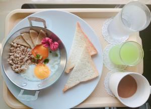 班佩环松塔里度假村的托盘,盘子上放着一盘食物,包括鸡蛋和烤面包