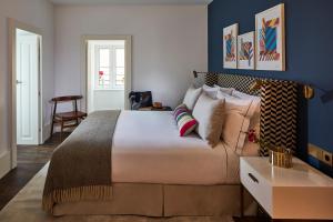 里斯本The Lumiares Hotel & Spa - Small Luxury Hotels Of The World的一间卧室配有一张带蓝色墙壁的大床