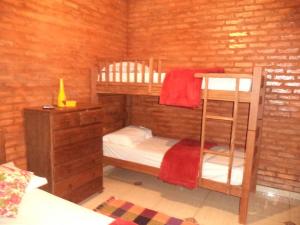 圣罗克迪米纳斯Chales Recanto das Seriemas的一间卧室设有两张双层床和梯子