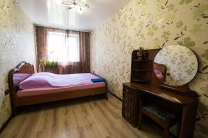 新库兹涅茨克Apartments on Kirova 76的一间小卧室,配有一张床和镜子