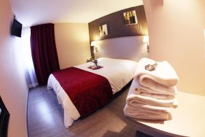 La Farlède科多酒店的酒店客房,配有带毛巾的床
