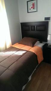 康塞普西翁Hotel con C的一间卧室配有一张大床和黑色床头板