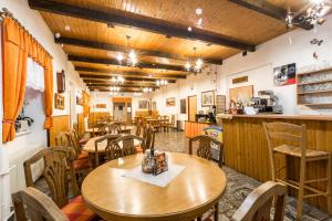 泽勒兹纳·鲁达格拉迪欧酒店的餐厅设有木桌、椅子和柜台