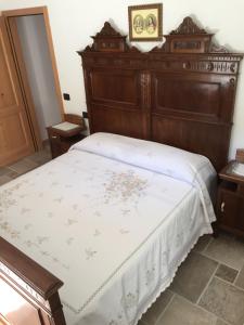 科马诺泰梅Casa Luigina的一间卧室配有一张大床和木制床头板