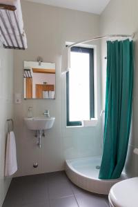 奥尔塔H18的浴室设有绿色的淋浴帘和水槽