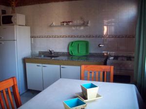 Las CallesCabañas Llajta Sumaj的厨房里设有一张桌子,上面有绿色的容器