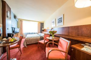 普热罗夫佳纳酒店的酒店客房带一张床、一张桌子和椅子