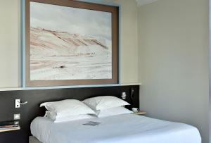 阿尔勒卡隆德尔Spa酒店的一间卧室配有一张床铺,上面有一张图片